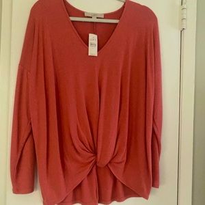 Coral color knit top with knot at bottom front. New with tags.